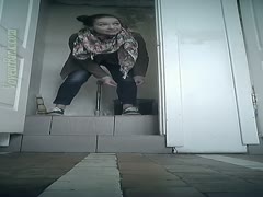 In the bathroom, a gorgeous and young, dark-brown, legal adolescent is urinating on a webcam.
